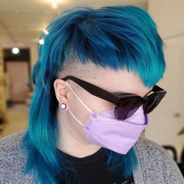 Blue Punk Mullet with Shaved Side Undercut- a woman wearing a face mask and sun-glass
