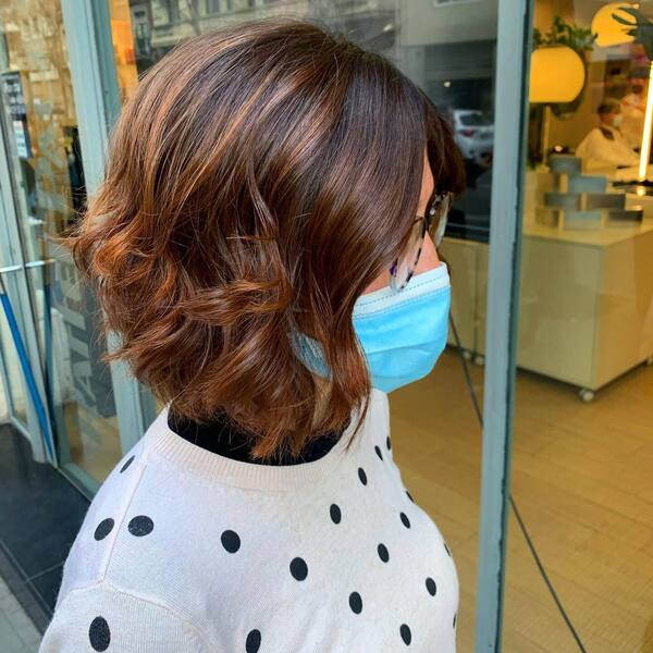 Brown Hair with Bronzed Brown Highlights- a woman wearing a blue face mask