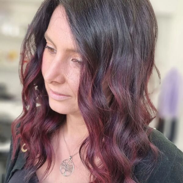 Brunette with Magenta Highlights- a woman wearing a black blouse