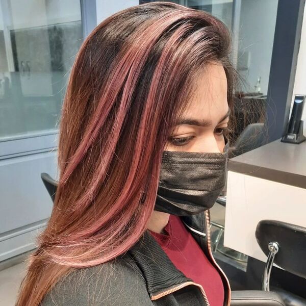 Brunette with Pink Highlights and Light Brown Undertones- a woman wearing a black face mask