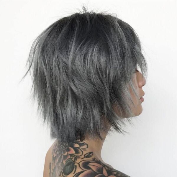 Charcoal Gray Messy Hair Style- a woman with a tattooed body