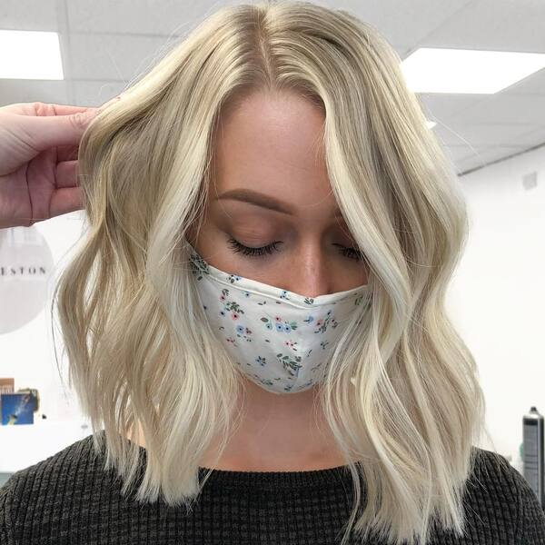 Creamy Blonde and Gold Blonde Hair Color Ideas- a woman wearing a face mask