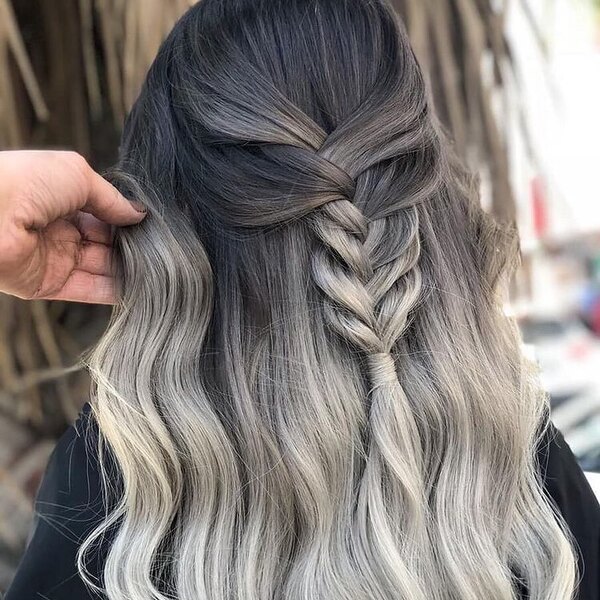 Dark Hair with Braided Ombre Gray Highlights- a woman wearing a black barber's cape