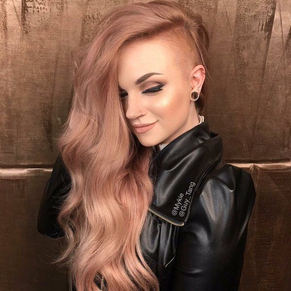 Delicate Side Undercut with Long Wavy & Ombre Hair- a woman wearing a black leather jacket