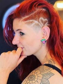 Fiery Red Long Hair with Side Shaved Design Undercut- a woman wearing an earring