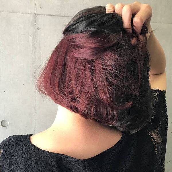 Hidden Deep Maroon Purple Hair Highlights- a woman wearing a black blouse