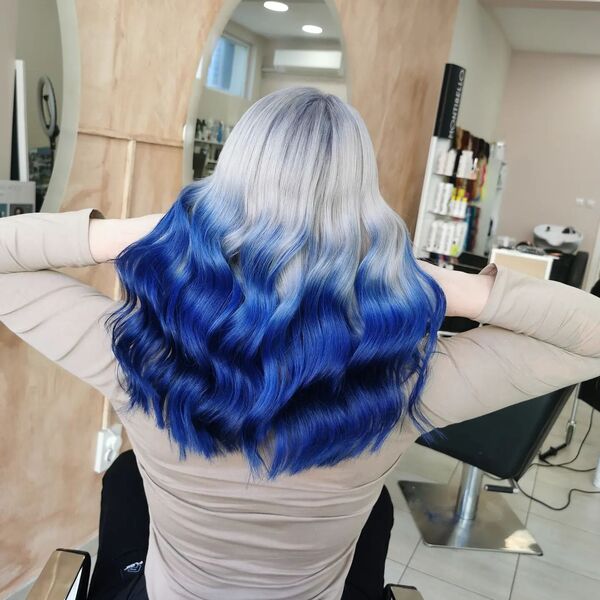 Ice Blonde to Dark Blue Reverse Ombre- a woman wearing a gray sweater
