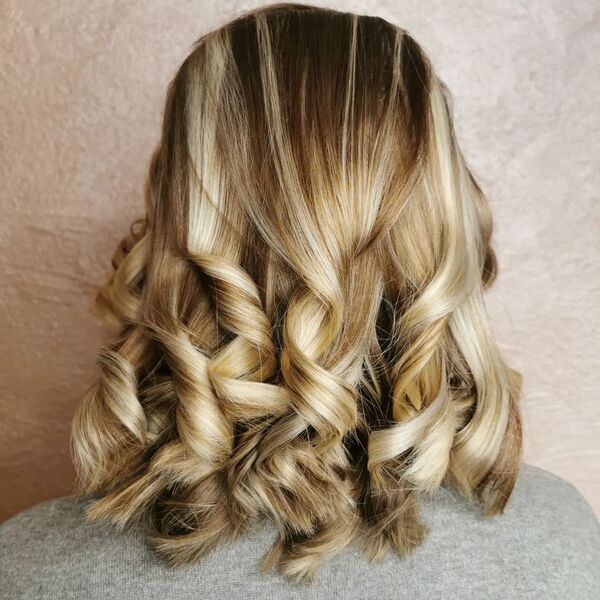 Lob Curls with Ombre Blonde- a woman wearing a gray shirt