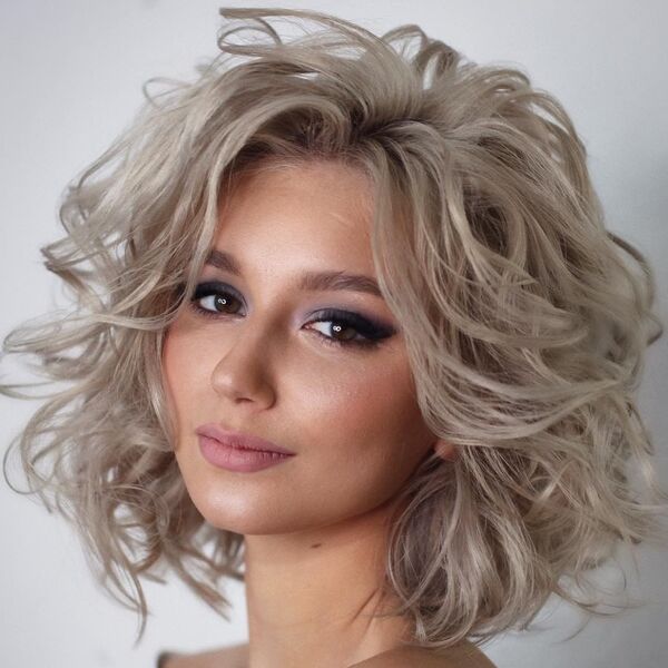 Messy Bob Curls with Ice Blonde- a woman with make-up