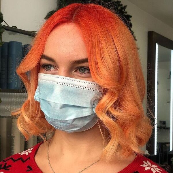 Orange Roots to Peach Ombre- a woman wearing a face mask