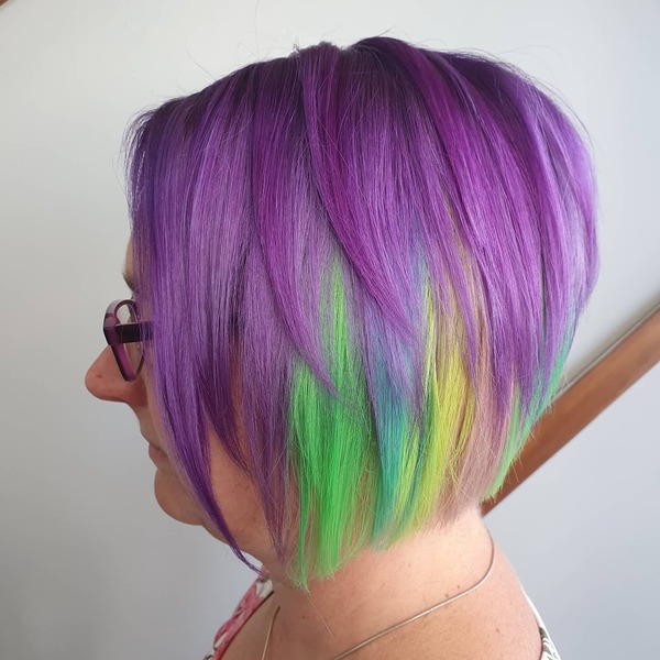 Pixie Cut with Purple Haze and Hidden Rainbow Hair- a woman wearing an eye glass