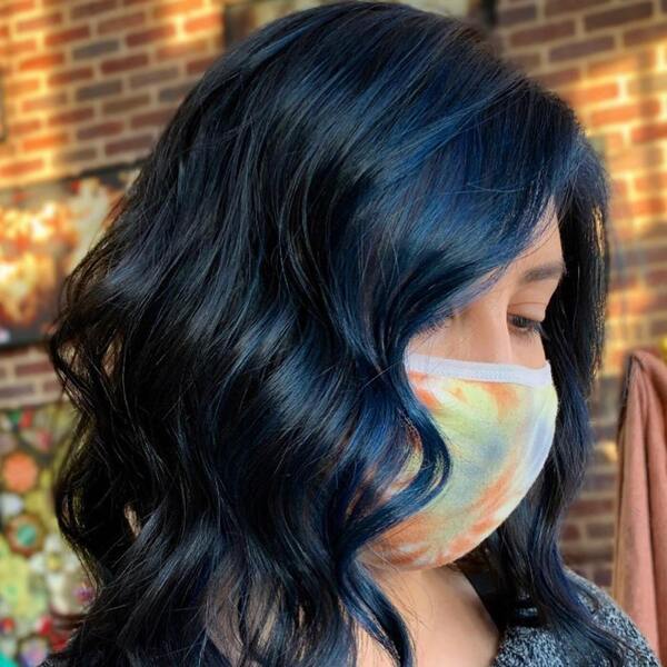 Raven Hair with Blue Highlights and Overtone- a woman wearing a face mask