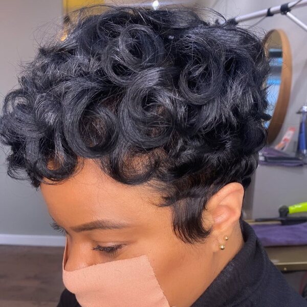 Short Black Hair with Messy Curls and Ash Gray Highlights- a woman wearing a black turtle neck dress