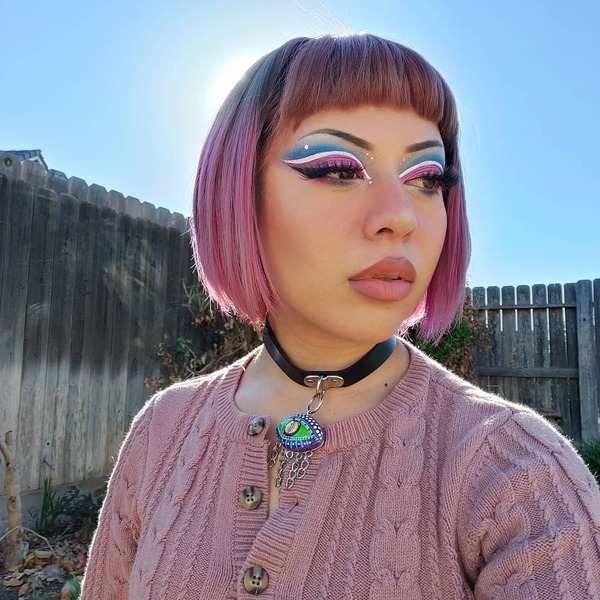 Short Bob Hair with Pink Lavender Highlights and Baby Bangs- a woman wearing a pink blouse and a neck choker