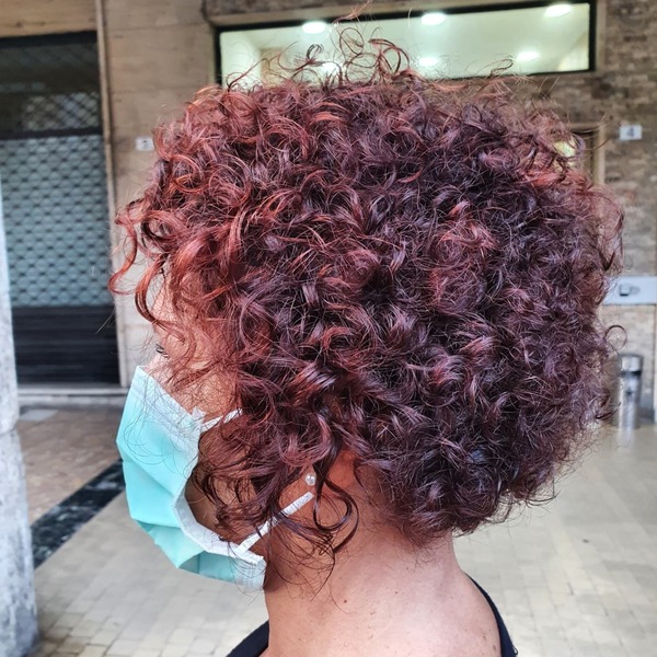 Short Curly Hair with Red Pigments- a woman wearing a face mask