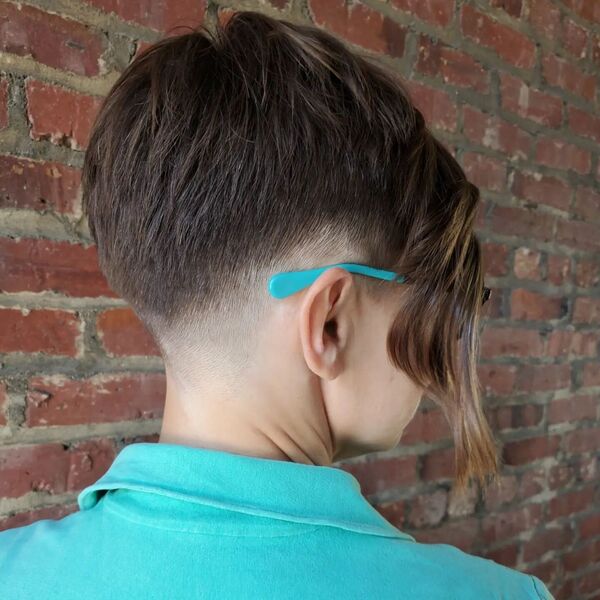 Side and Nape Undercut with Asymmetrical Pixie Cut- a woman wearing a light green polo shirt