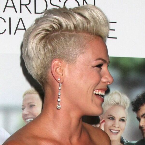 Side and Nape Undercut with Pompadour-Style Hair- a woman wearing an earring