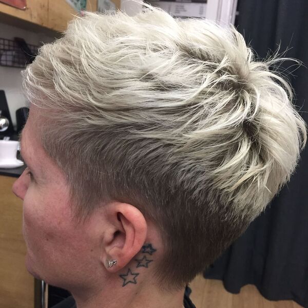 Side and Nape Undercut with Silver Short Hair and Bangs- a woman wearing an earring
