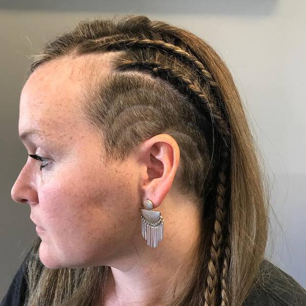 Viking-Style Side Undercut with Long Hair and Braids- a woman wearing an earring