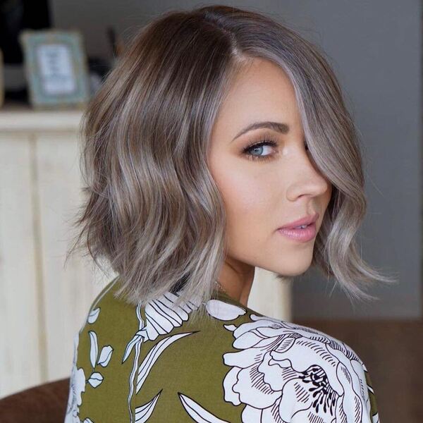 Wavy Bob Cut with Dark Ash and Ice Blonde- a woman wearing a floral blouse