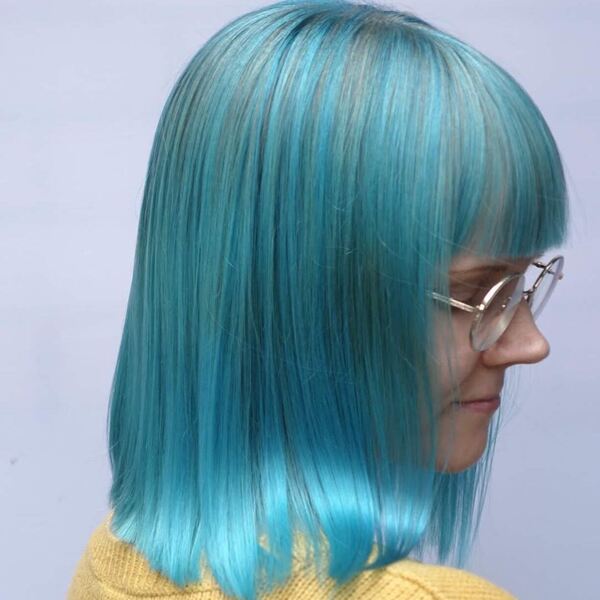 Aqua Blue Hair Color- a woman wearing an eyeglass and a yellow sweater