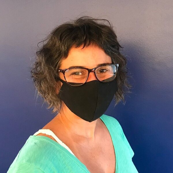 Baby Bangs- a woman wearing a black face mask