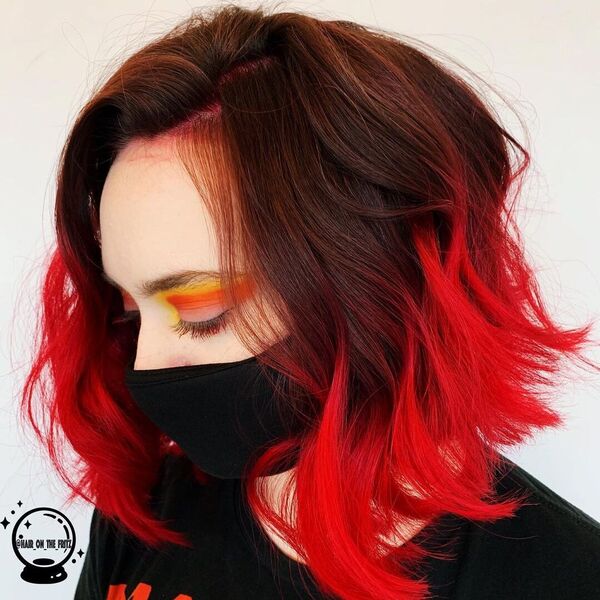 Black and Fire Red Hair Color Combo- a woman wearing a black face mask and a black t-shirt