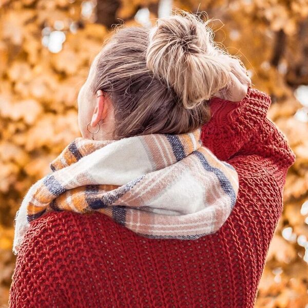 Blonde Ombre for Fall Hair Colors- a woman wearing a scarf and a red sweater