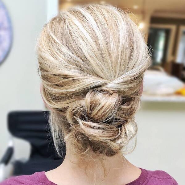 Blonde Updo Hairstyle with Highlights- a woman wearing a maroon t-shirt