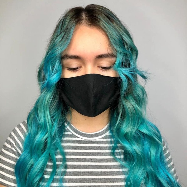 Blue Green Hair Color with Brown Root- a woman wearing a black face mask