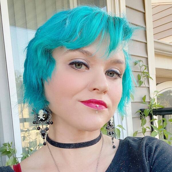 Blue Messy Hairstyles- a woman wearing a black blouse