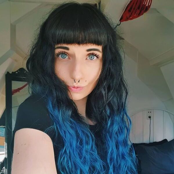 Blue Ombre with Black Bangs Hairstyle- a woman wearing a black t-shirt