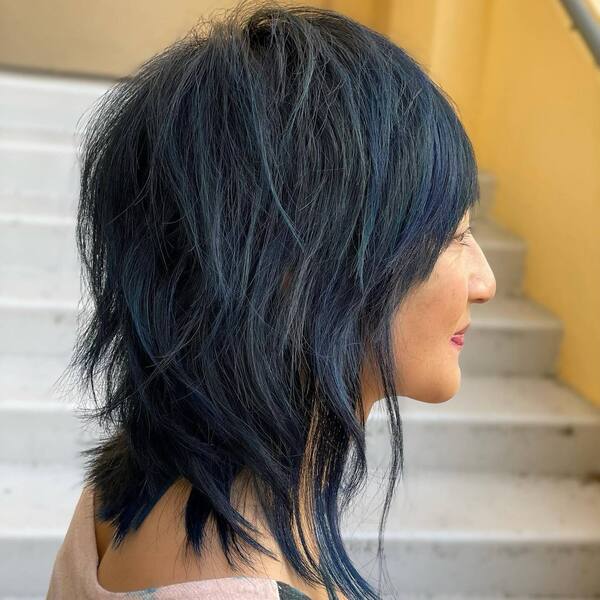 Blue Streaks Shag Hairstyles- a woman wearing a peace camisole