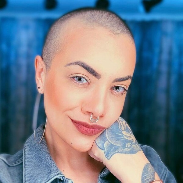 Bold Shaved Hairstyles for Women- a woman wearing a denim jacket