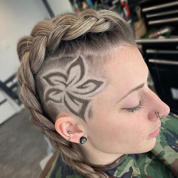 Braided Top with Flower Shaved Design- a woman wearing a barber's cape