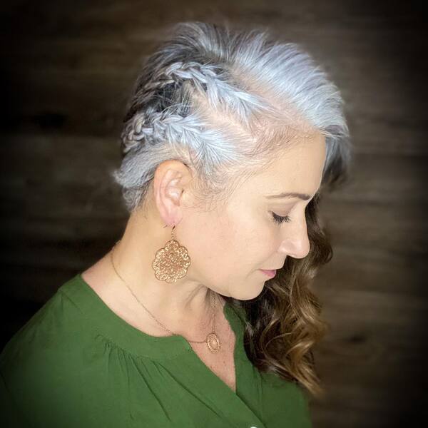 Braids for Growing Out Gray Hair- a woman with gray hair wearing a green blouse