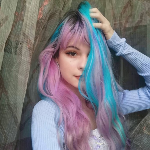 Bright Baby Blue Highlights on Pastel Pink Hair- a woman wearing a pastel purple sweater
