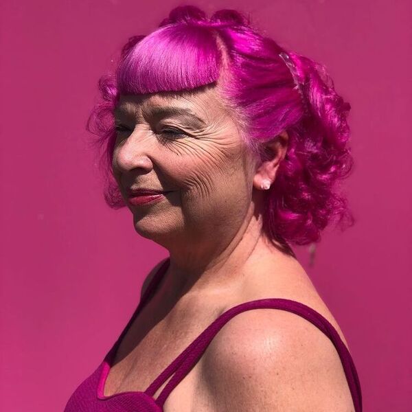 Bright Magenta Hairstyles- a woman wearing a pink camisole