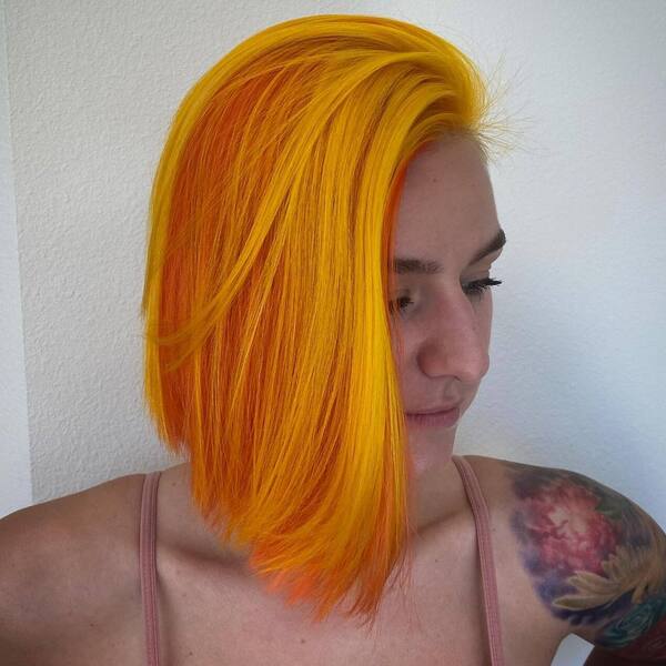 Bright Neon Orange Hairstyles for Thick Hair- a woman wearing a pink camisole
