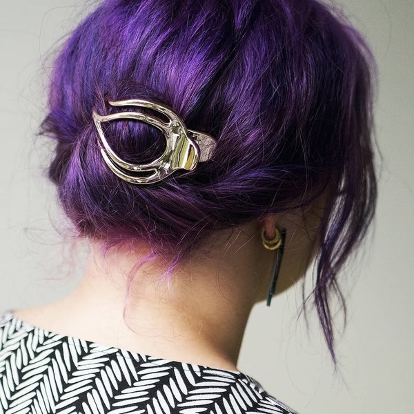Bright Purple Updo for Medium Hair- a woman wearing an earrings
