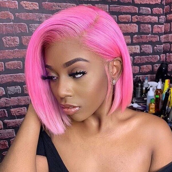 Bubblegum Pink Hairstyles- a woman wearing a black off-shoulder blouse