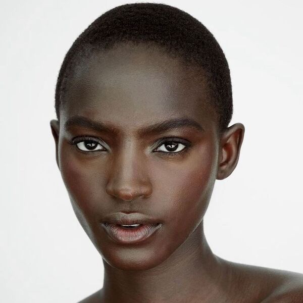 Buzz Cut for Black Women- a black woman wearing a lip-tint