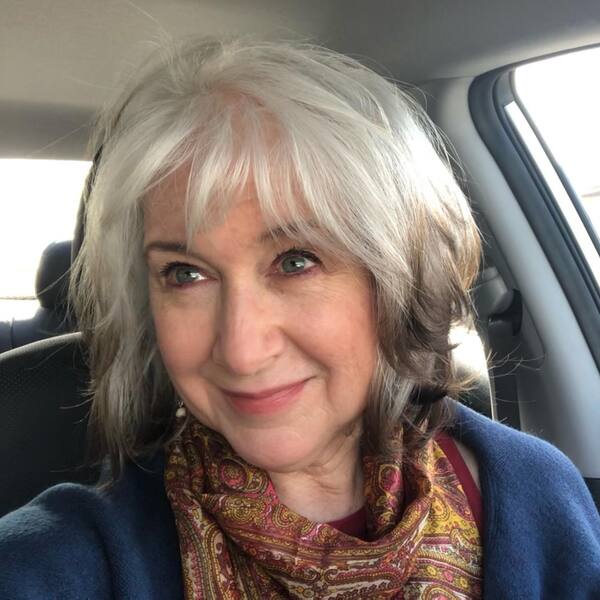 Celebrity Hairdo- a woman with gray hair wearing a red scarf