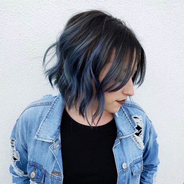 Charcoal Roots with Steel Blue Highlights- a woman wearing a denim jacket with black shirt