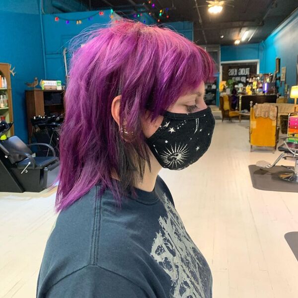 Choppy Purple Hairstyle- a woman wearing a black face mask