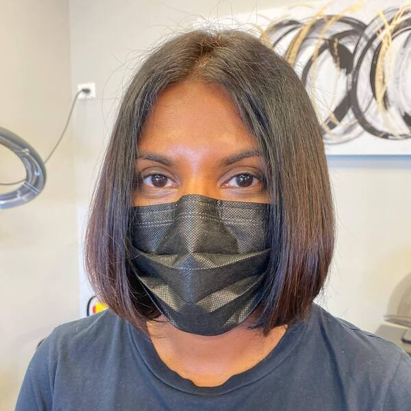 Classic Bob Cuts- a black woman wearing a black face mask and a black t-shirt