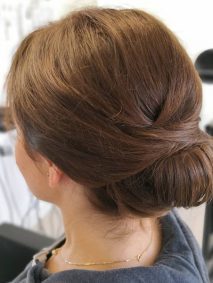 Classic and Easy Updo for Medium Hair- a woman wearing a gray jacket