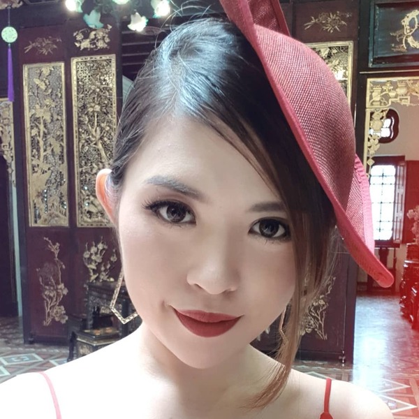 Classical Asian Hairstyles- an Asian woman wearing a red tradition hat