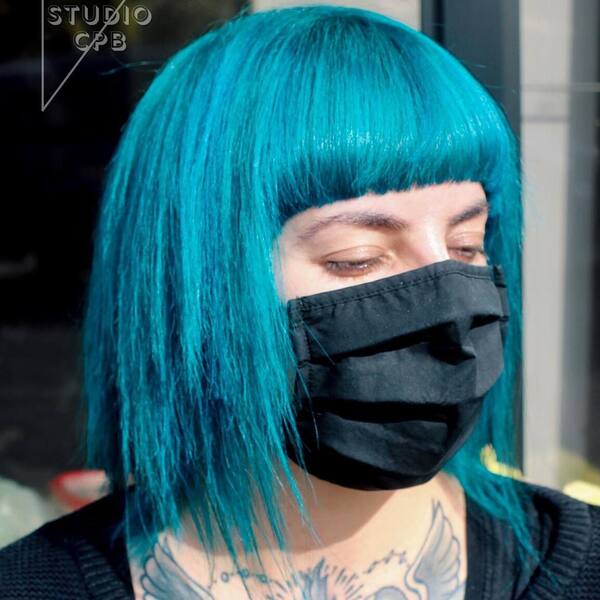 Clear Blue Sky for Fall Hair Color- a woman wearing a black face mask