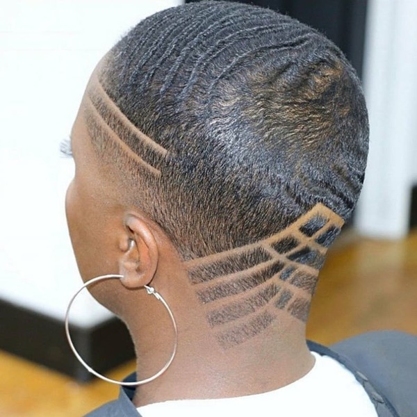 Close Shaved Haircuts for Black Women- a black woman wearing a big earrings